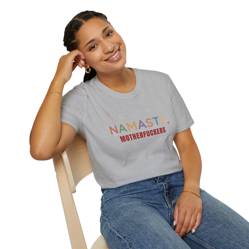 Smiling woman sitting on a chair wearing the "Namaste, Motherfuckers" funny yoga T-shirt by SarcasmArt in Athletic Heather – a funny gift for yoga lovers.