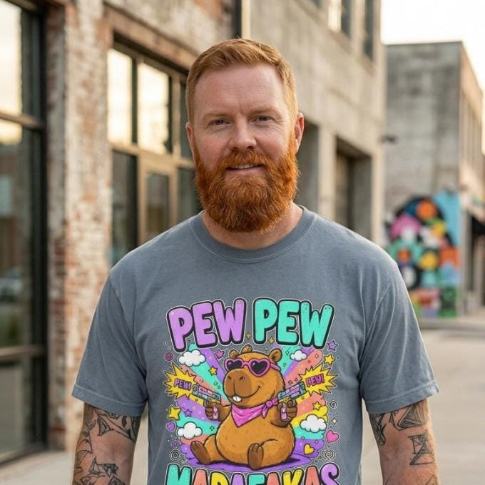 Bearded man on a city street wearing the "Pew Pew Madafakas" capybara meme T-shirt by SarcasmArt in Blue Jean.