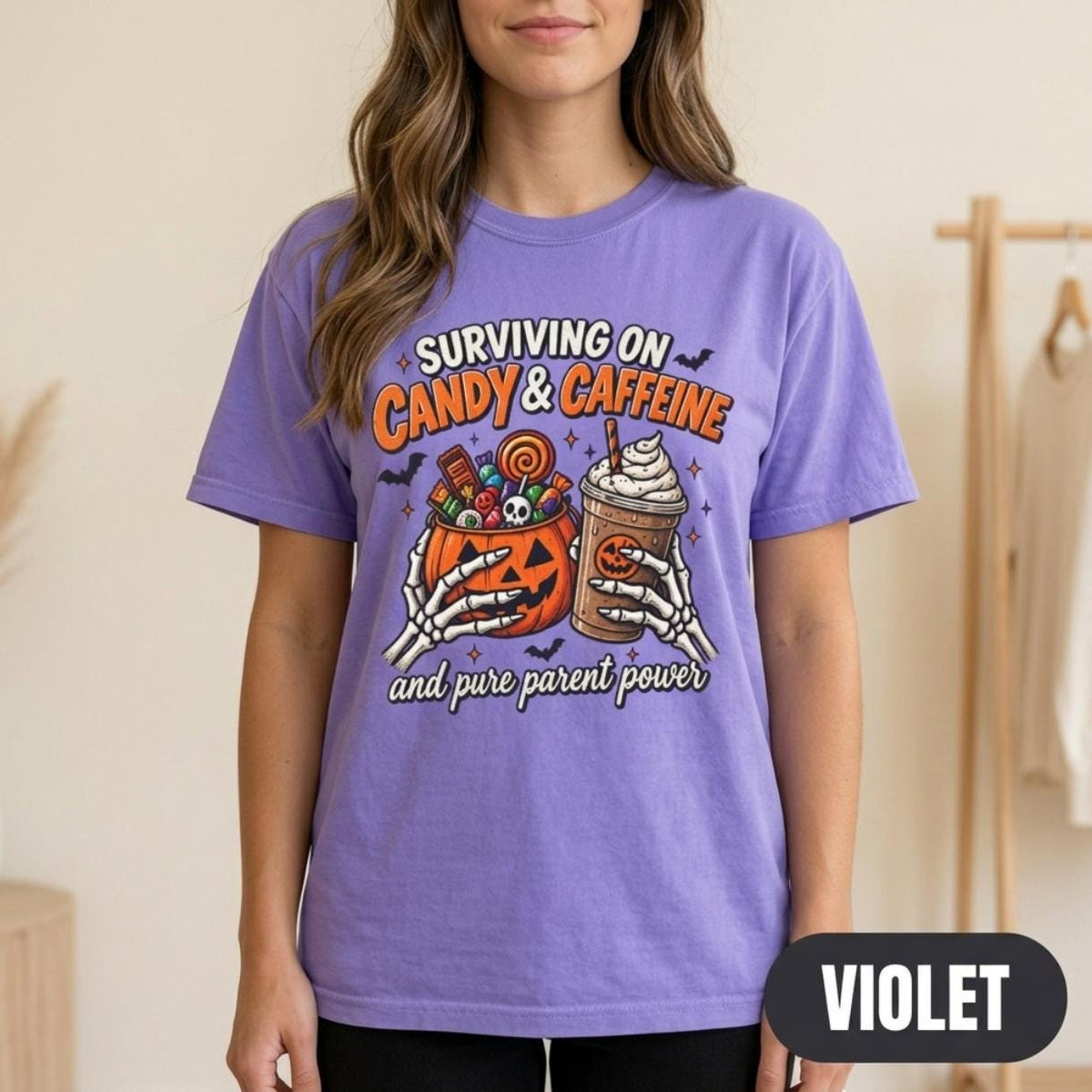Woman wearing the "Surviving on Candy & Caffeine" Halloween mom T-shirt by SarcasmArt in Violet.