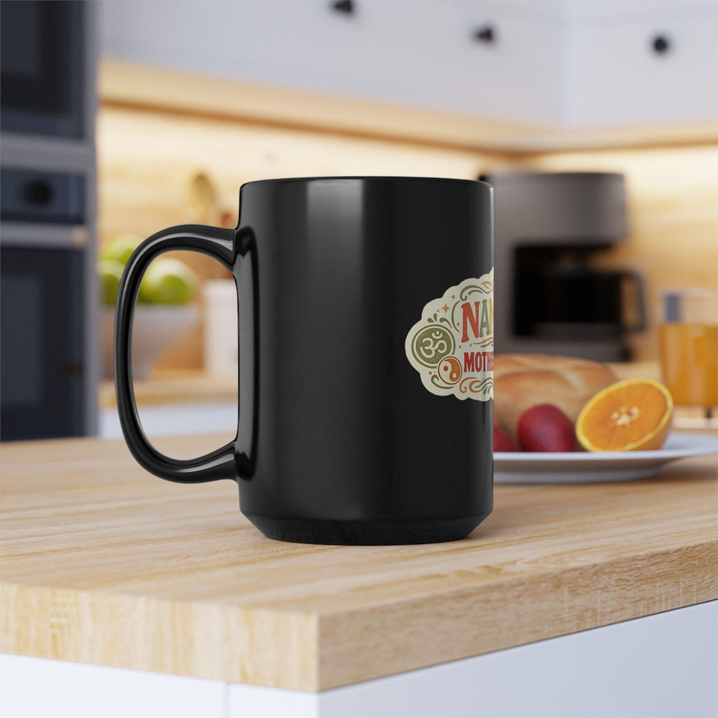 Handle view of the black "Namaste Motherfuckers" funny yoga coffee mug by SarcasmArt on a kitchen counter – adult spiritual humor for your morning coffee.