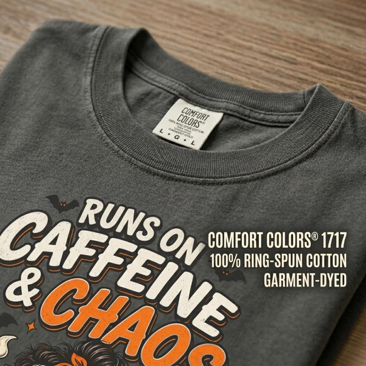 Fabric close-up of the "Runs on Caffeine & Chaos" skeleton coffee Halloween T-shirt by SarcasmArt in Pepper: garment-dyed Comfort Colors 1717, 100% ring-spun cotton, with the skeleton coffee print.