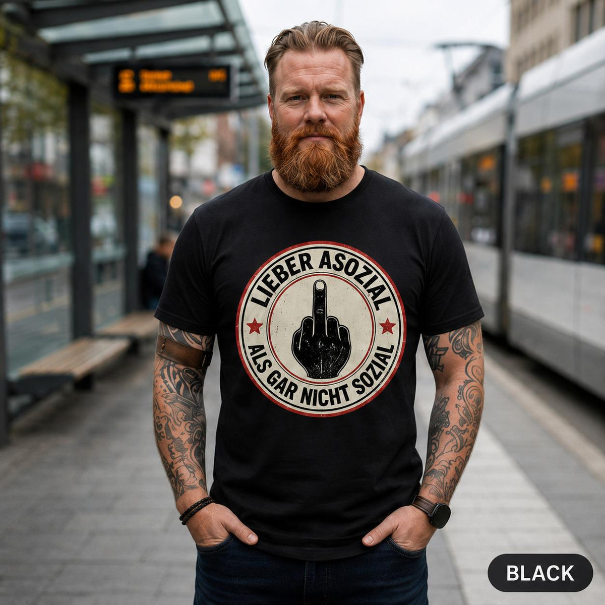 Bearded man on a train platform wearing the "Lieber asozial als gar nicht sozial" middle finger T-shirt by SarcasmArt in Black.