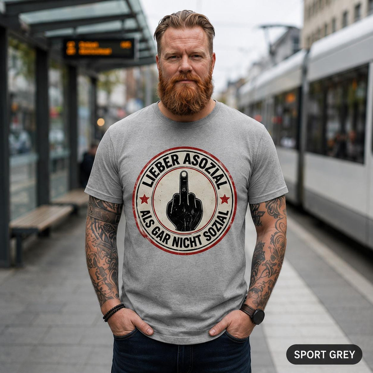 Bearded man on a train platform wearing the "Lieber asozial als gar nicht sozial" middle finger T-shirt by SarcasmArt in Sport Grey.