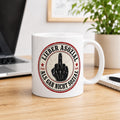 "Lieber asozial als gar nicht sozial" middle finger coffee mug by SarcasmArt: white 11 oz ceramic mug with a round red-and-black badge with a middle finger hand and the German slogan LIEBER ASOZIAL ALS GAR NICHT SOZIAL (better antisocial than not social at all), on a wooden desk next to a laptop.
