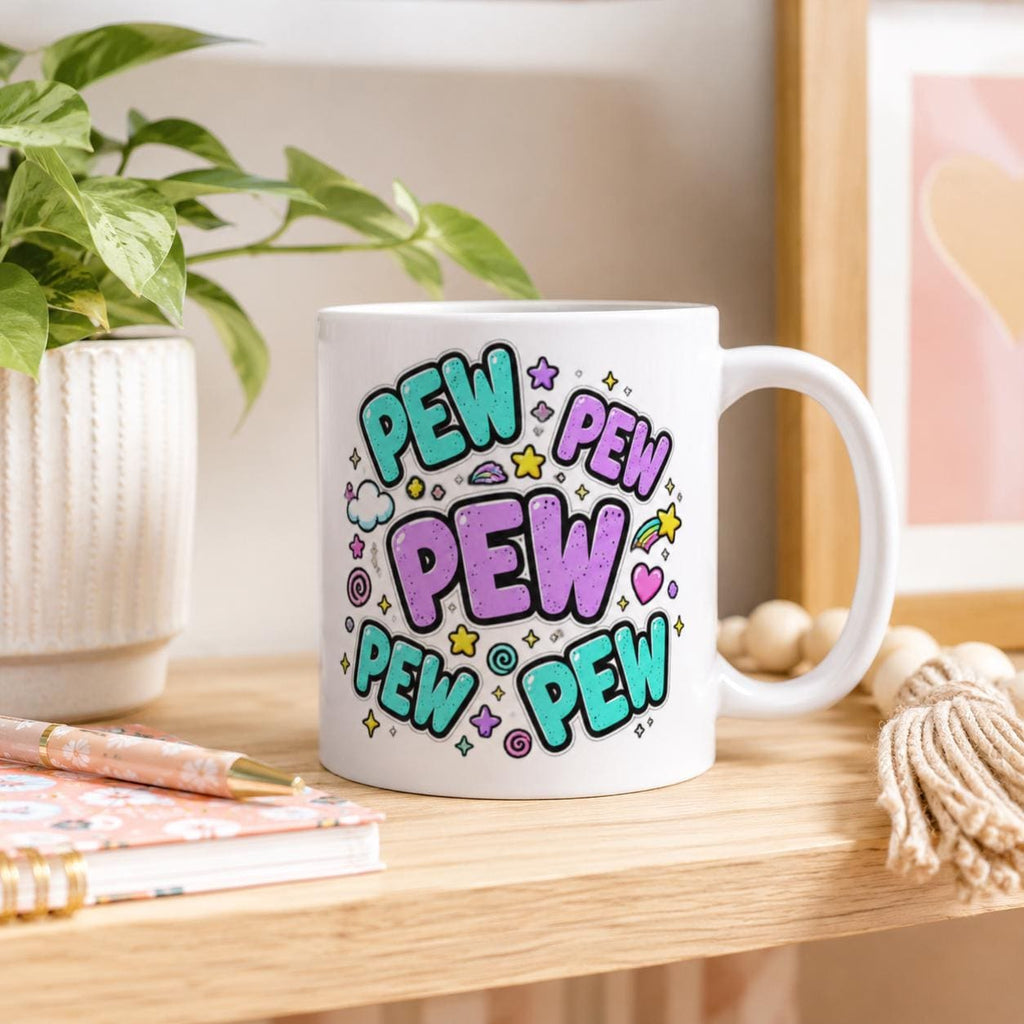 Back side of the "Pew Pew Madafakas" capybara coffee mug by SarcasmArt with colorful PEW PEW PEW lettering, on a desk with books.