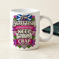 "I'm Scottish, We Dinnae Dae That Keep Calm Crap" funny Scottish mug by SarcasmArt: white 11 oz glossy ceramic mug with a Scottish saltire, purple thistles and pink tartan banners with the slogan I'm SCOTTISH – we dinnae dae that KEEP CALM CRAP, next to a tartan blanket.