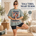 Yoga vibes, sharp humor: woman in tree pose wearing the "Namaste Motherfuckers" funny yoga T-shirt by SarcasmArt in Bay (sage green).