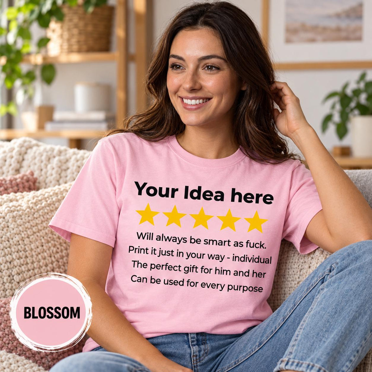 Smiling woman on a cozy sofa wearing the personalized golden 5-star review T-shirt for light colors by SarcasmArt in Blossom.