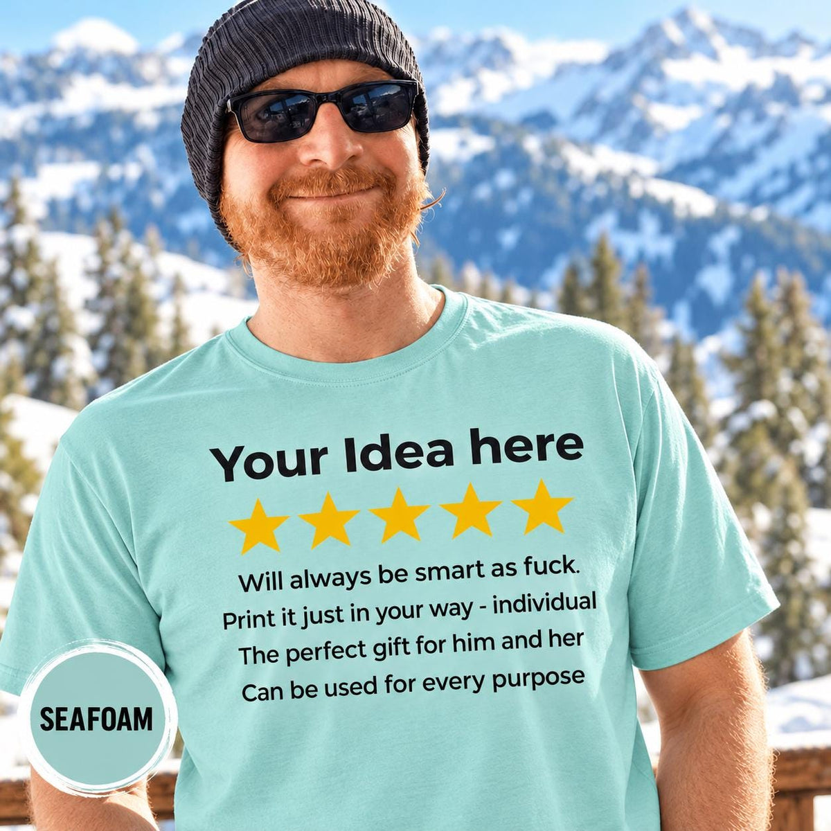 Bearded man in a beanie and sunglasses in front of snowy mountains wearing the personalized golden 5-star review T-shirt for light colors by SarcasmArt in Seafoam.