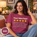 Smiling woman on a sofa wearing the personalized golden 5-star review T-shirt by SarcasmArt in Berry.