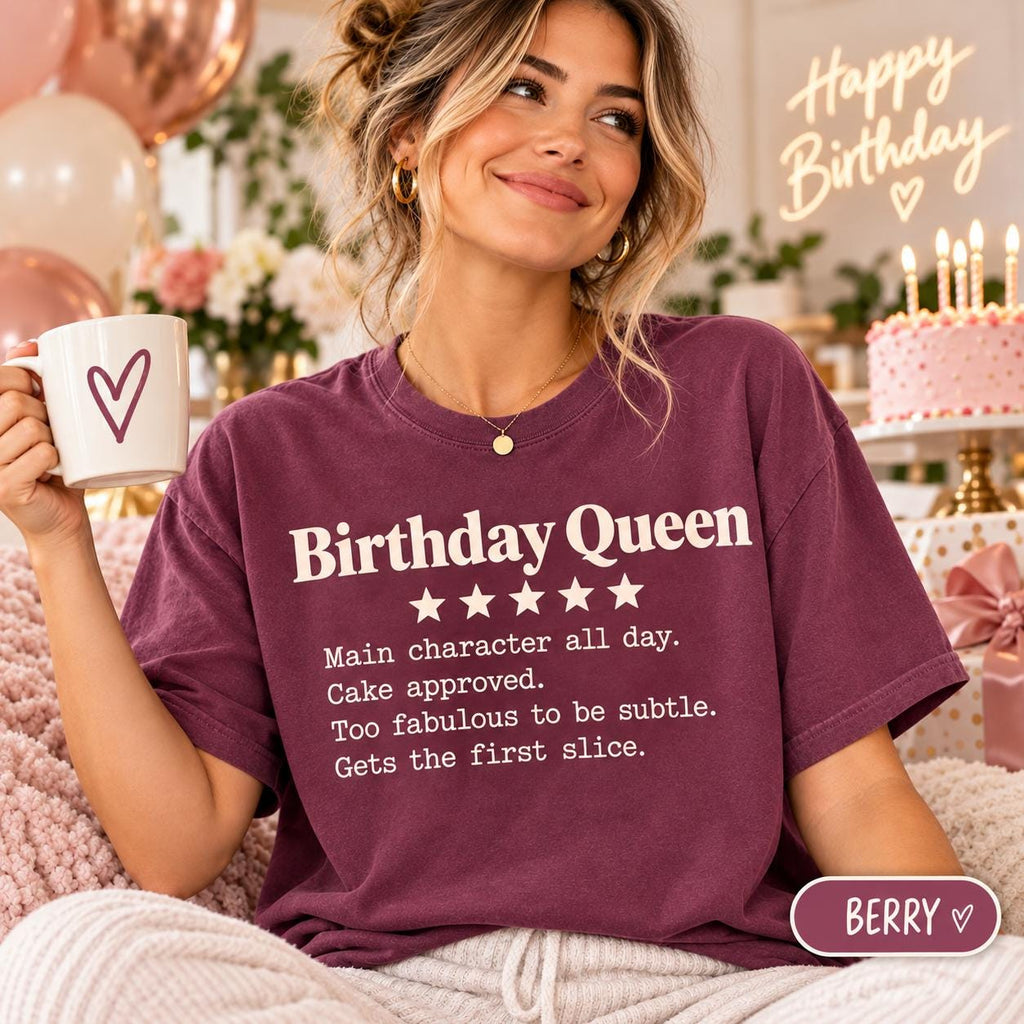 Personalized example: woman wearing the personalized 5-star review T-shirt by SarcasmArt in Berry reading Birthday Queen in front of a birthday cake.