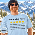Bearded man in a beanie and sunglasses in front of snowy mountains wearing the personalized golden 5-star review T-shirt for light colors by SarcasmArt in Chambray.