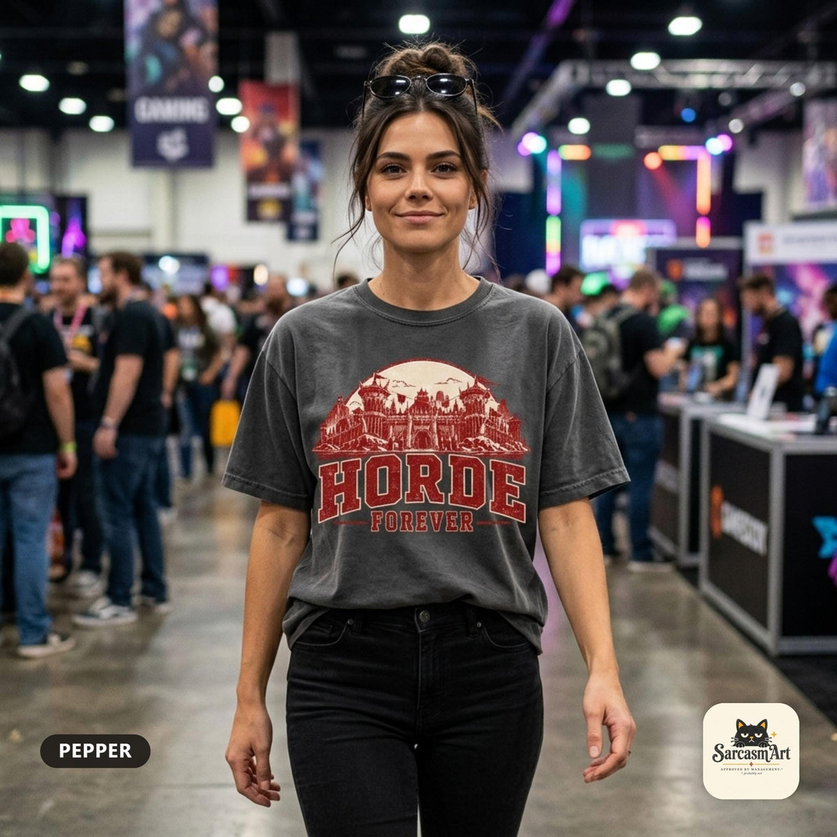 Woman at a busy gaming convention wearing the "Horde Forever" World of Warcraft gamer T-shirt in Pepper (washed charcoal) – a Comfort Colors 1717 unisex tee by SarcasmArt with red distressed HORDE FOREVER varsity lettering over a gothic fantasy castle skyline.
