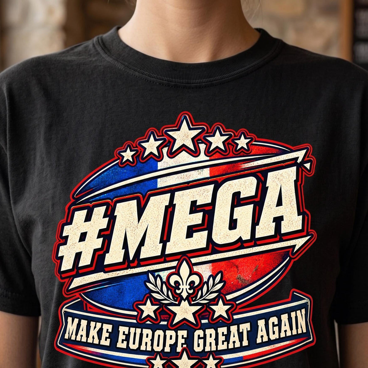Close-up of the "#MEGA Make Europe Great Again" France T-shirt by SarcasmArt in Black: a retro #MEGA sports badge with the blue-white-red French tricolore, a fleur-de-lis emblem with laurel, stars and a MAKE EUROPE GREAT AGAIN banner, printed large on a garment-dyed Comfort Colors 1717 tee.