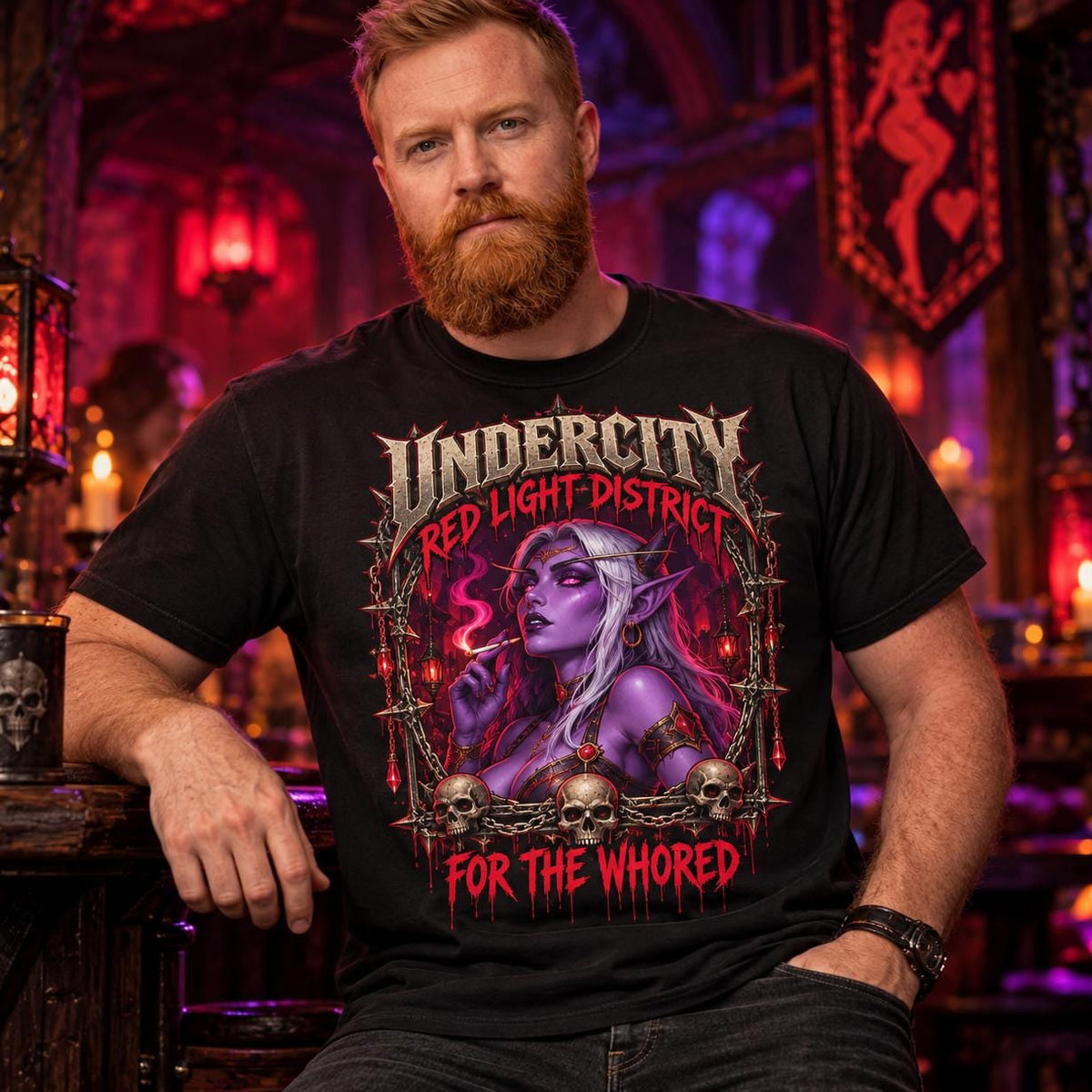 Bearded man sitting in a gothic fantasy tavern with a red banner, wearing the Black "Undercity Red Light District" dark humor gamer T-shirt by SarcasmArt with a gothic Undercity badge with a purple-skinned undead elf, skulls, roses and dripping red lettering.