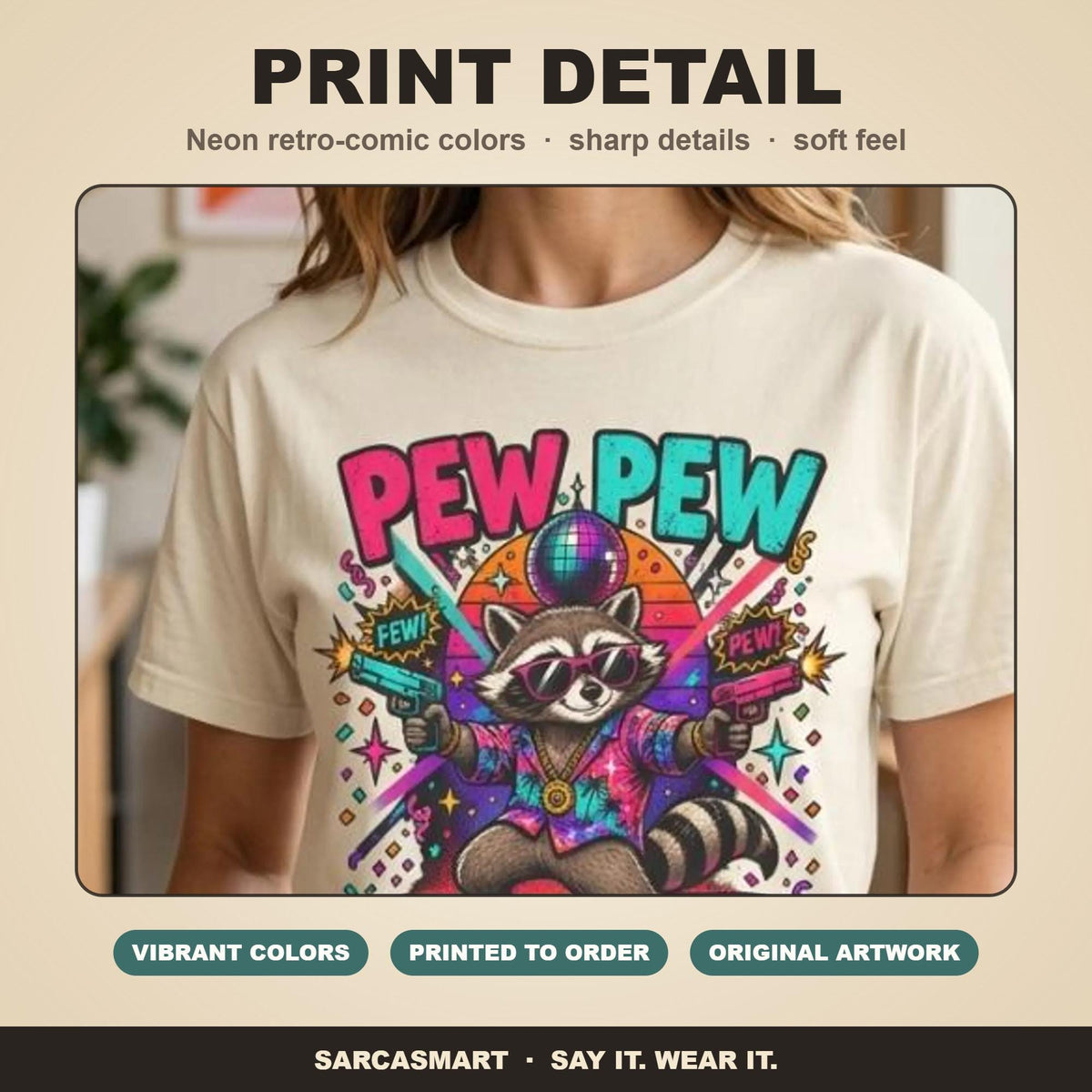 Print detail of the "Pew Pew Madafakas" raccoon meme T-shirt by SarcasmArt: bold retro neon colors, sharp details and a soft feel on garment-dyed cotton.