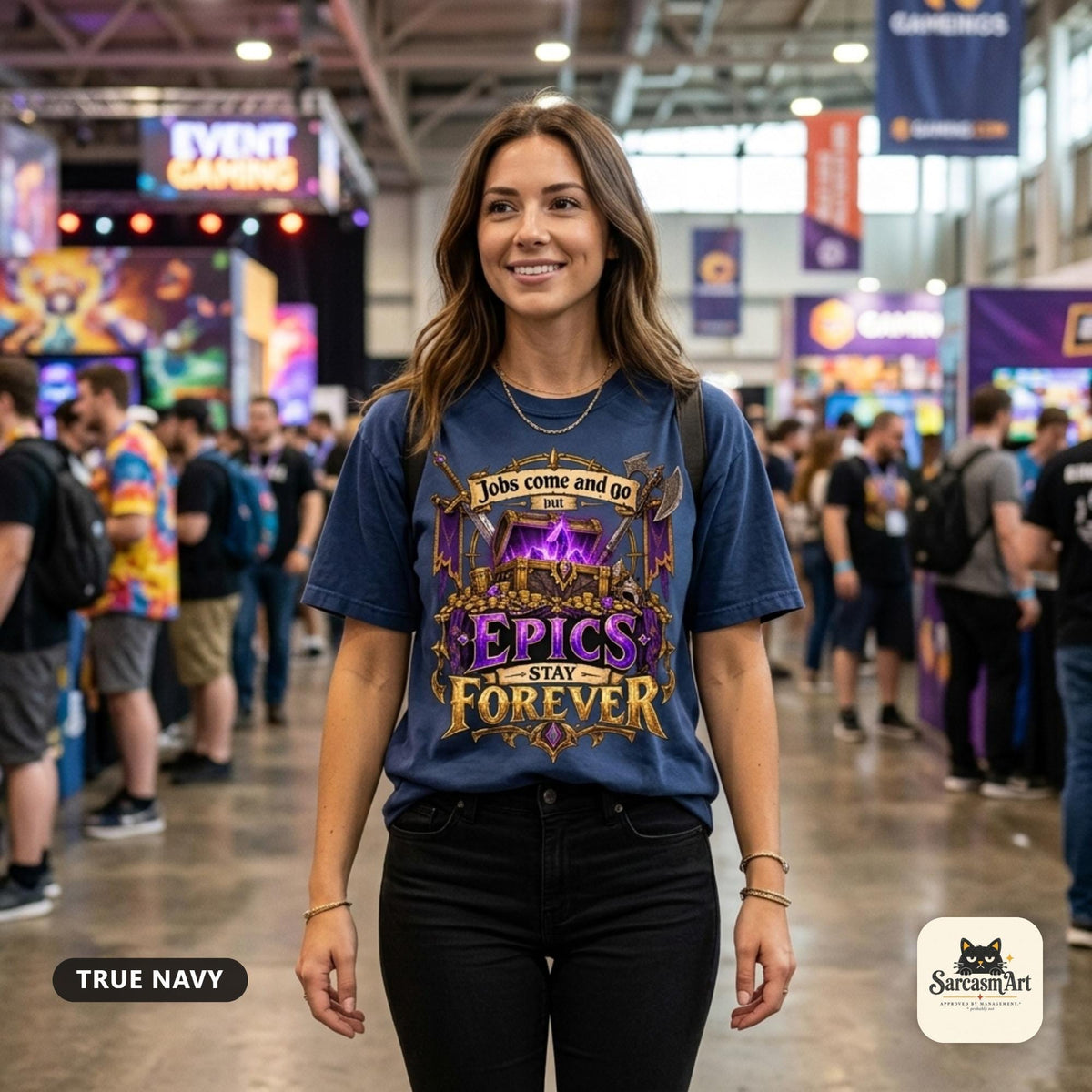 Woman at a busy gaming convention wearing the "Epics Stay Forever" funny gamer T-shirt in True Navy – a Comfort Colors 1717 unisex tee by SarcasmArt with the quote "Jobs come and go but EPICS STAY FOREVER" above a glowing purple loot chest in a gold fantasy frame with crossed axes.