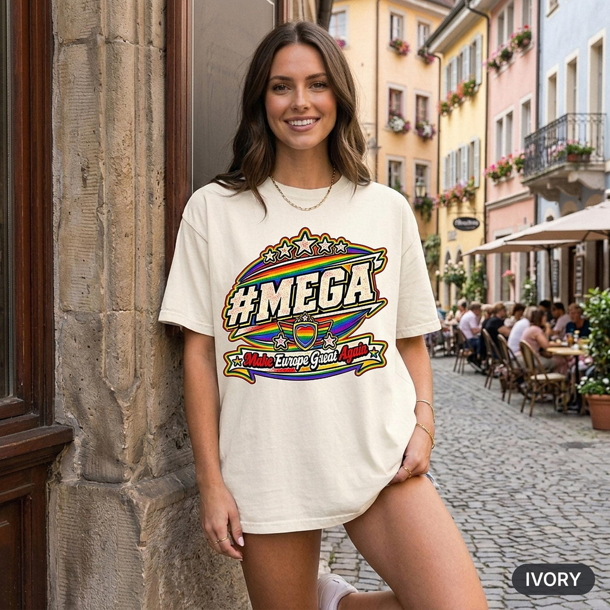 Woman on a cobblestone street with café terraces wearing the "#MEGA Make Europe Great Again" Rainbow Pride T-shirt by SarcasmArt in Ivory.
