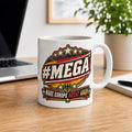 "#MEGA Make Europe Great Again" Germany coffee mug by SarcasmArt on a wooden desk next to a laptop and plant: white 11 oz (325 ml) glossy ceramic mug with a retro #MEGA badge in black-red-gold with a German eagle shield and a MAKE EUROPE GREAT AGAIN banner.