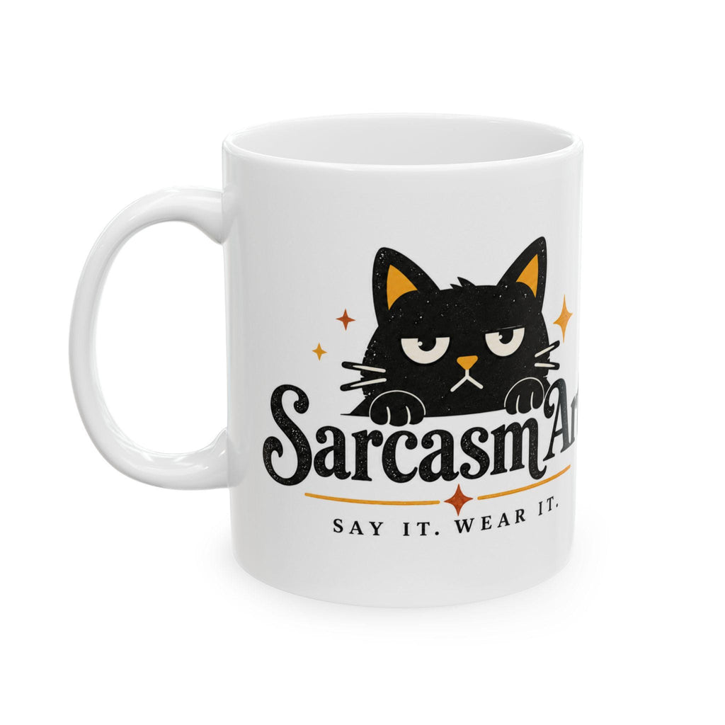 May include: A white ceramic mug featuring a black cat illustration with a grumpy expression. The text reads SarcasmArt and below it, SAY IT. WEAR IT. The design includes small orange star accents and a horizontal line separating the text.