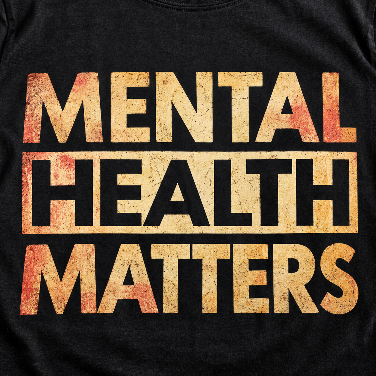 Print close-up of the "Mental Health Matters" vintage awareness T-shirt by SarcasmArt in Black: bold distressed MENTAL HEALTH MATTERS block lettering in a cream-to-gold vintage gradient with HEALTH in an outlined box.