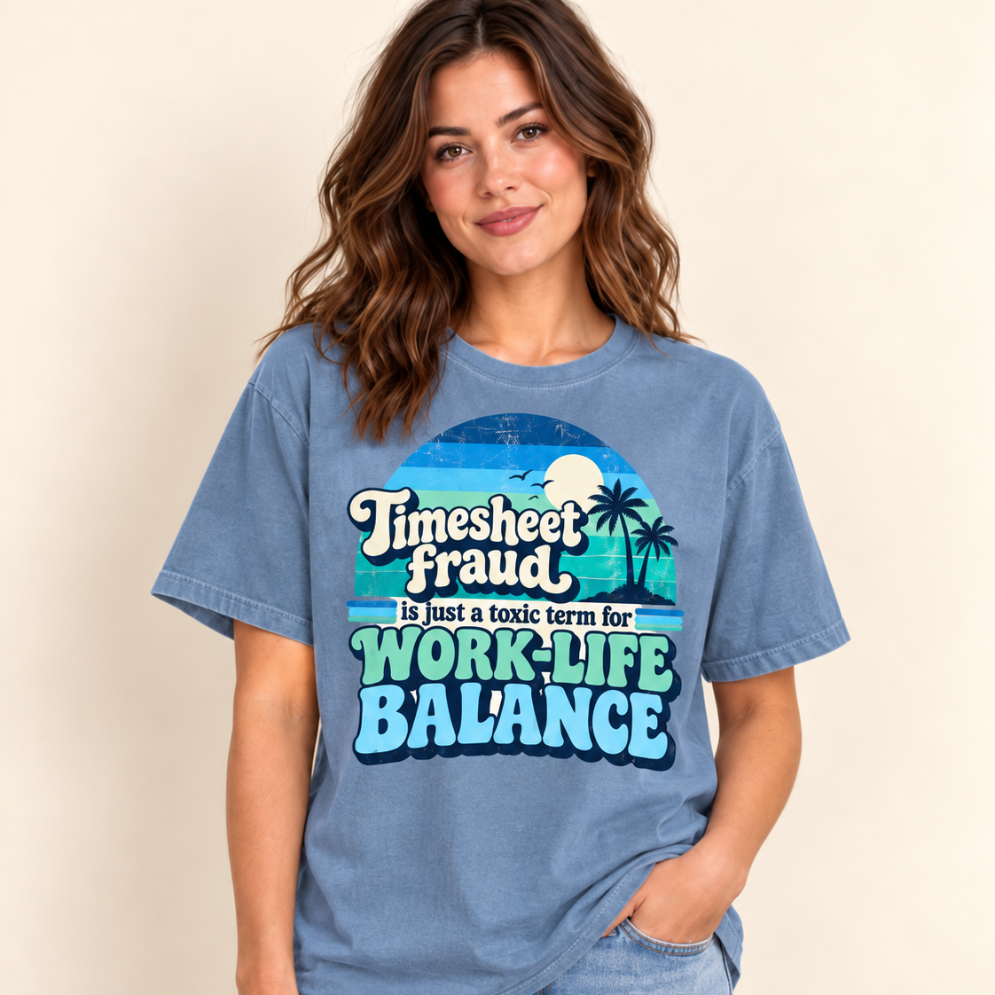 Smiling woman in jeans wearing the "Timesheet Fraud Is Just a Toxic Term for Work-Life Balance" sarcastic work T-shirt by SarcasmArt in Blue Jean (washed denim blue).
